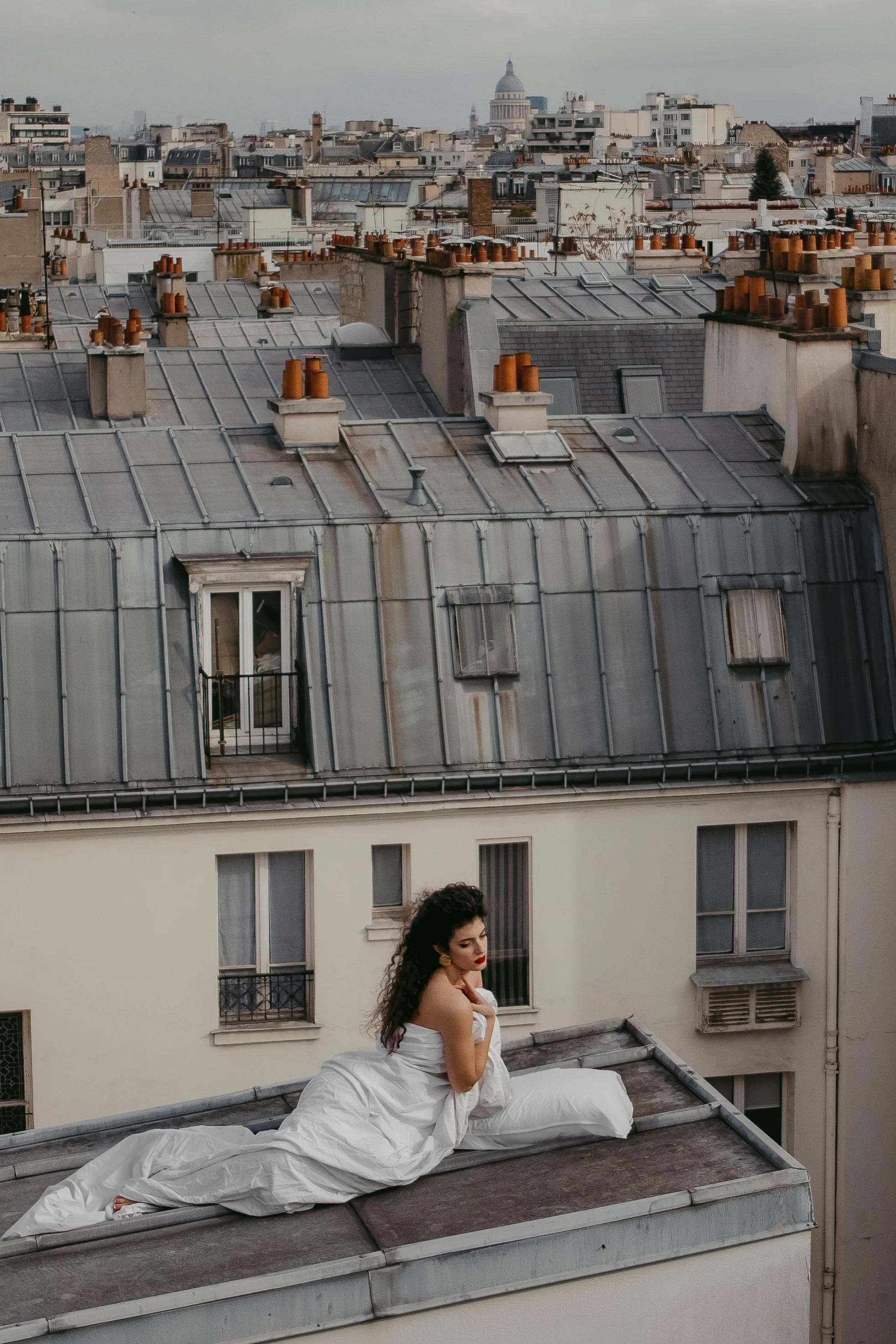 Virna on the rooftops in a white dress